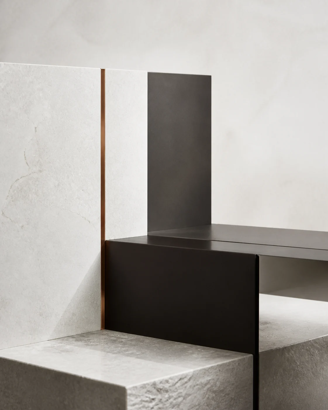 Abstract composition of mineral stone, dark metal, and a precise copper inlay